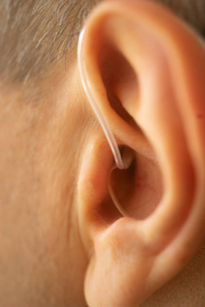 istock Modern digital hearing aid in ear of middle aged 40s 50s man 1310551181