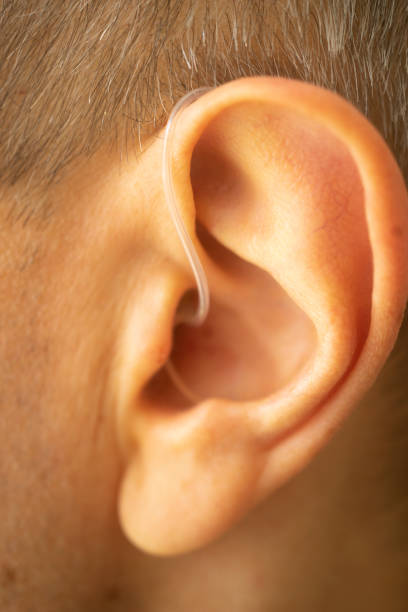 istock Modern digital hearing aid in ear of middle aged 40s 50s man 1310551183