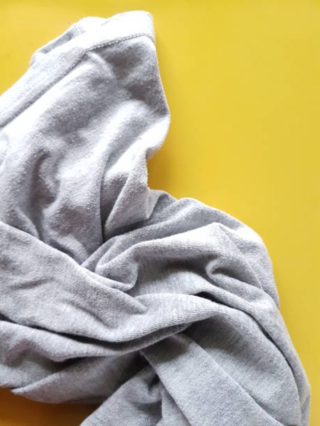 istock Still life with gray cloth on a yellow background 1310556154