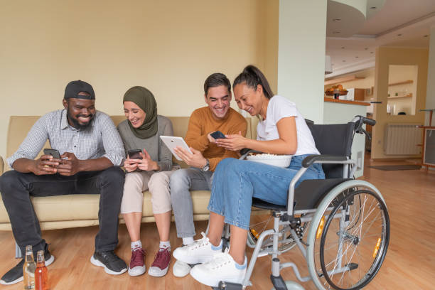 istock Enthusiastic Multi-Ethnic Friends are Hanging Out in the Living Room While Browsing the Internet Content. 1310557220
