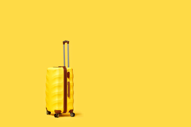istock Travel suitcase on yellow background. copy space for text 1310559585