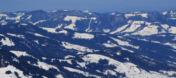 istock Snow covered hills, forest and farmland. 1310559658