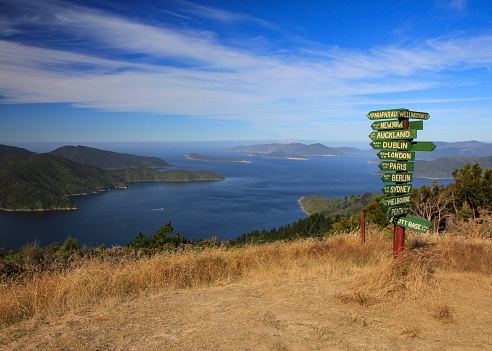 International directional signs and Queen Charlotte Sound, New Zealand.