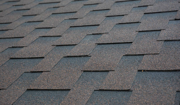 istock Architectural, dimensional asphalt shingles roofing material background.  Brown, copper asphalt shingle roofing texture. 1310561816