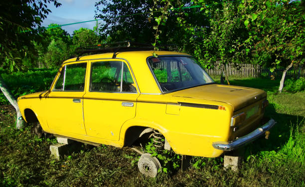 istock Yellow faulty retro soviet's car without wheels on grass 1310562787