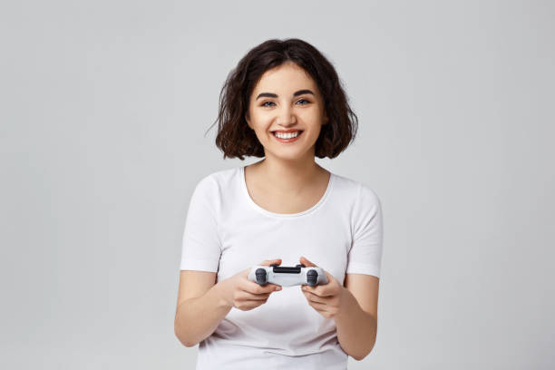 istock girl playing video games on gray background 1310562828