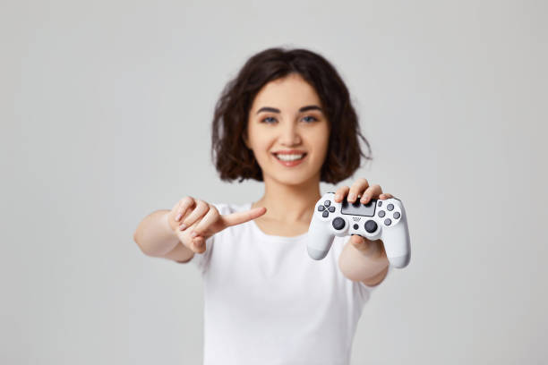 istock girl playing video games on gray background 1310562841
