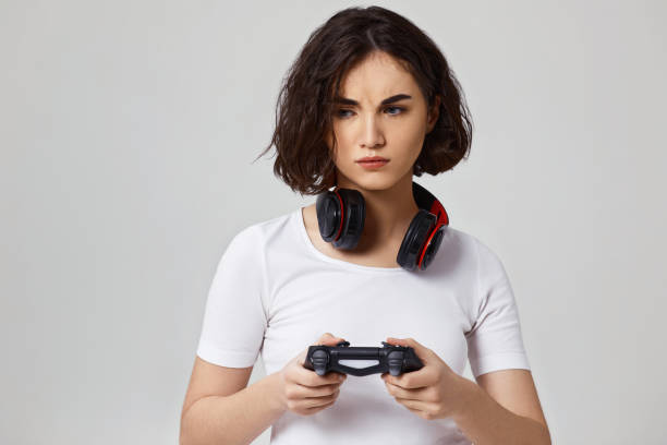istock girl playing video games on gray background 1310562922