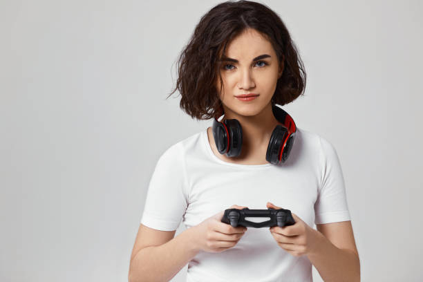 istock girl playing video games on gray background 1310562933
