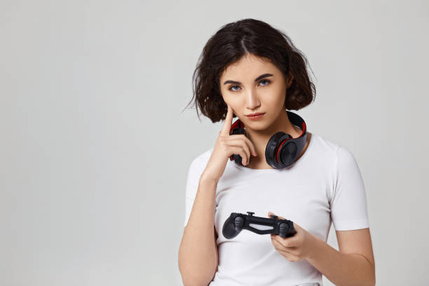 istock girl playing video games on gray background 1310562939