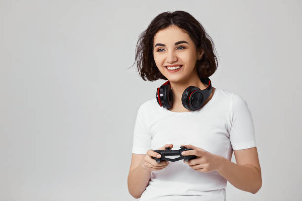 istock girl playing video games on gray background 1310562955
