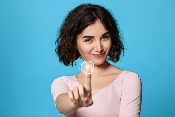 istock woman using touch screen on the blue background. 1310563558