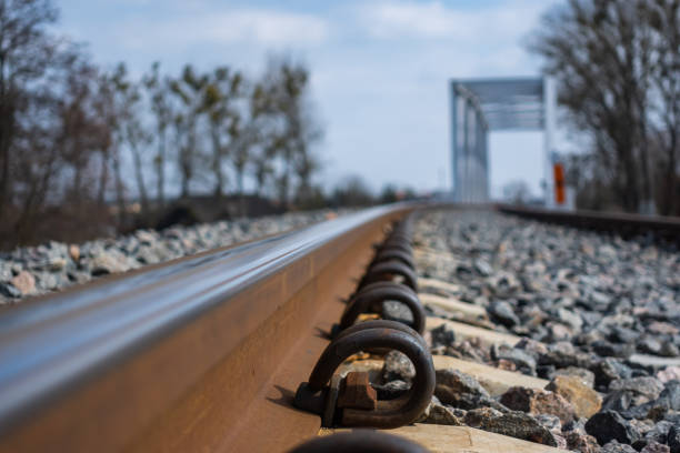 istock A close-up on rails and a railway bridge. 1310563625