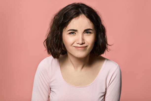 istock curly woman looking in camera with sarcastic expression 1310563669