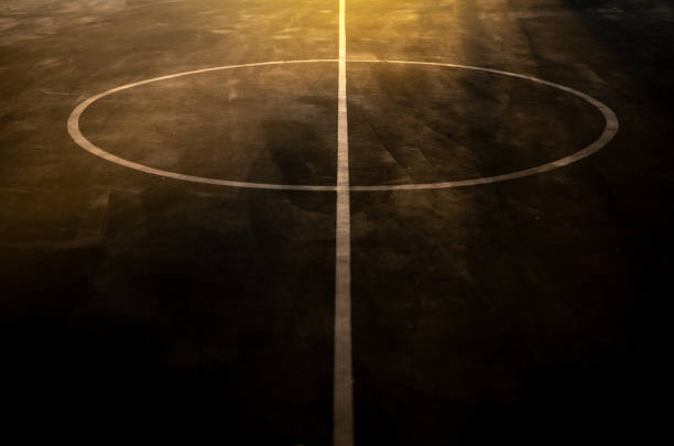 White center lines on concrete street basketball court Image of white lines on concrete floor with sunrise lighting. asphalt basketball court stock pictures, royalty-free photos & images