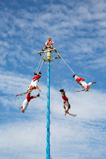 Tulum, Mexico - January 24, 2018: Voladores performing the dance of the flyers ritual at Tulum archeological site, Quintana Roo, Yucatan pensinsula, Mexico