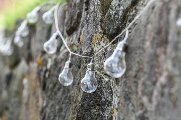 istock Light bulbs hanging on the rock under the decoration. 1310568403