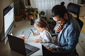 Father and daughter working together at home