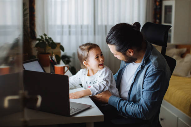 istock Father and daughter working together at home 1310569324
