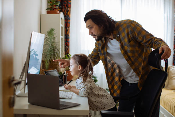 istock Father and daughter working together at home 1310569400