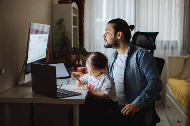 istock Father and daughter working together at home 1310569662