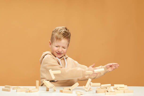 istock children plays with wooden constructor on desk. 1310573051