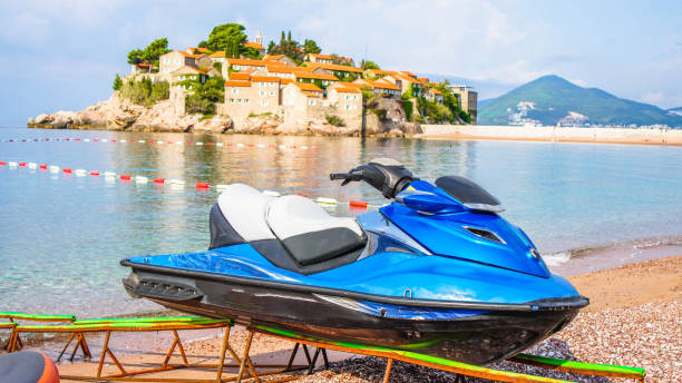 istock Front view of a blue jet ski parked on a white sandy 1310573208