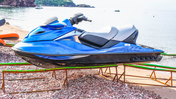 istock Front view of a blue jet ski parked on a white sandy 1310573210