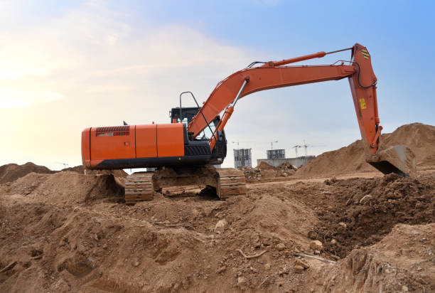 istock Excavator on earthworks at construction site. Backhoe on earthmoving and foundation work 1310578958