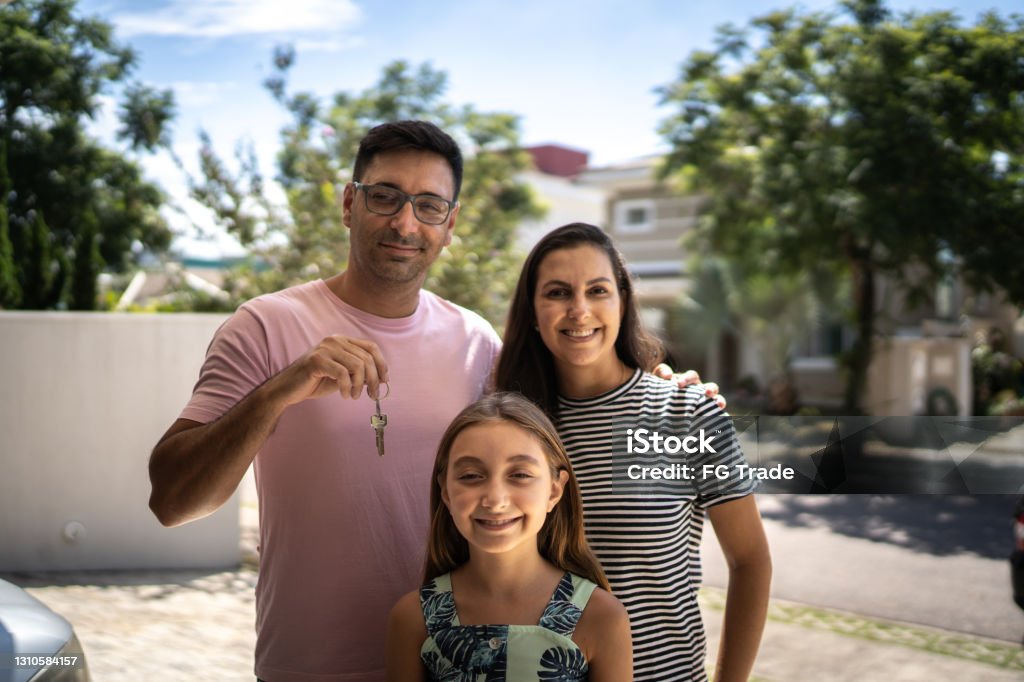 Portrait of family showing new house key Family Stock Photo