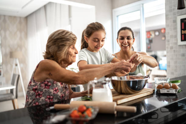 istock Multi-generation family preparing a bread/cake at home 1310584559