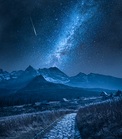 Milky way and falling star over Tatra mountain. Tourism in Poland. Mountain hiking at night.