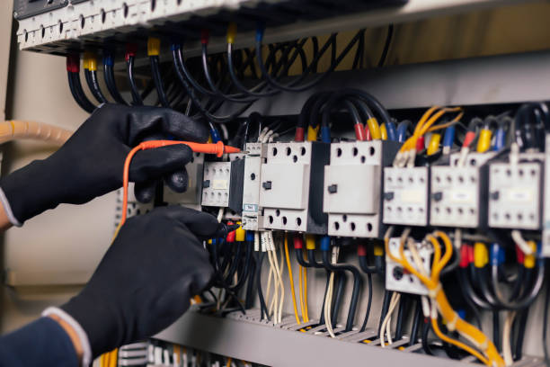 istock Electrician engineer work tester measuring voltage and current of power electric line in electical cabinet control.and wires on relay protection system. Bay control unit. Medium voltage switchgear. 1310588464