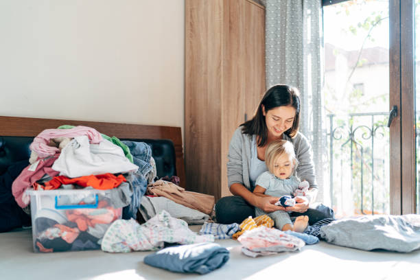 istock Mother And Daughter Sitting On Bed 1310589331