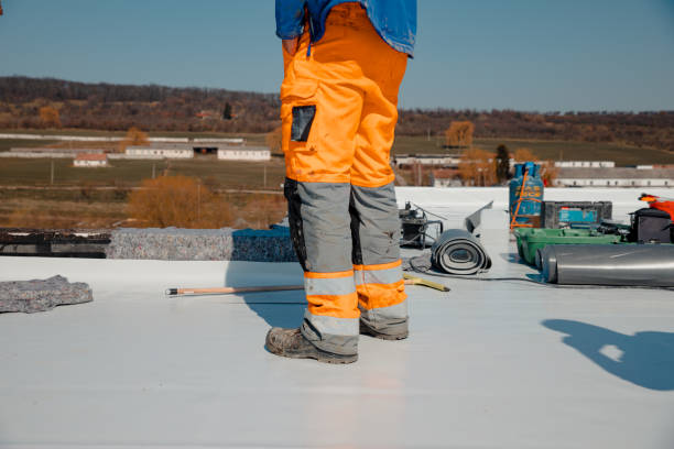 Worker prepares geotextile for the roof, covers it with synthetic PVC membrane Roofer man works on a flat roof with pvc membrane insulation system pvc stock pictures, royalty-free photos & images