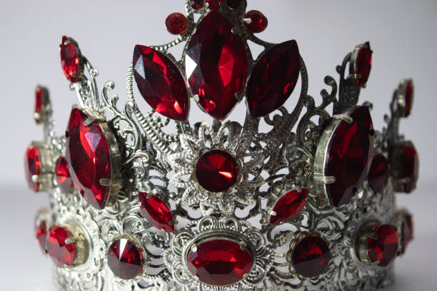 istock Crown on a white background, handmade, custom, individually, princess jewelry. Foreground. For girls. beautifully. fashion. Royal crown with red stones. Close-up