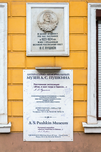 Odessa, Ukraine - APR 28, 2019: Commemorative plaque on a building in Odessa, Ukraine. In this building lived the famous Russian poet A.S. Pushkin, museum work schedule.