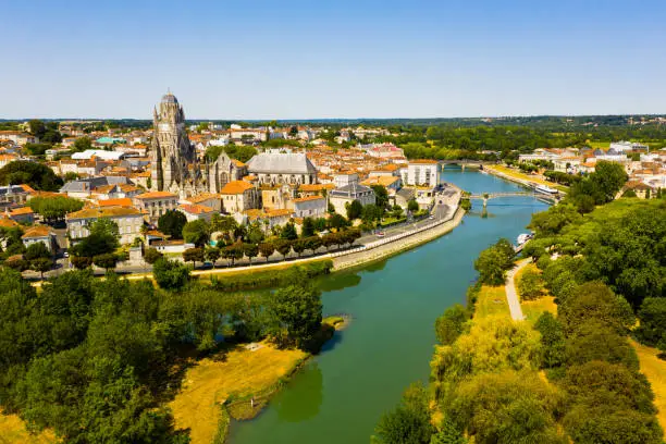 Picturesque summer view of historic areas of Saintes located on Charente river looking out over cathedral bell tower in Flamboyant Gothic style, Charente-Maritime, France