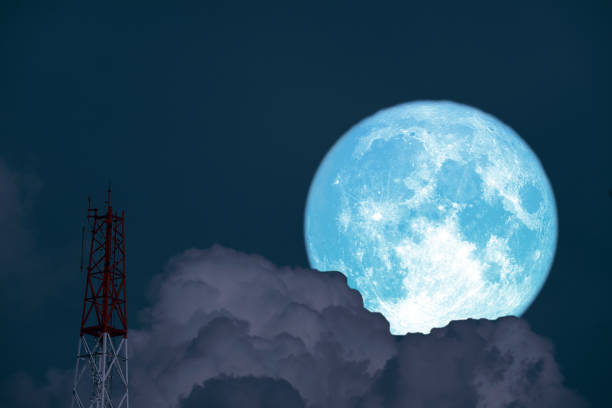 istock Full Snow Moon on night sky back silhouette signal pole 1310595614