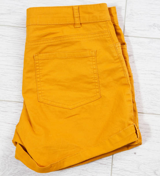 istock folded shorts close up top view on wooden background 1310597329