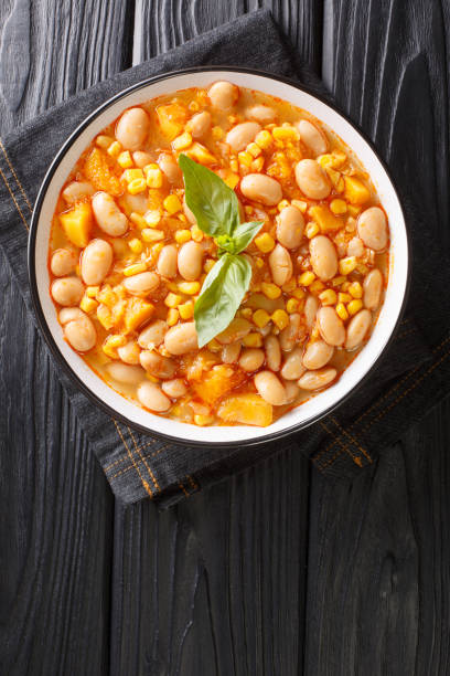 istock Beans stew with corn, pumpkin and onions close-up in a bowl. vertical top view 1310597462
