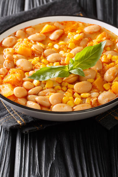 istock Beans stew with corn, pumpkin and onions close-up in a bowl. vertical 1310597642