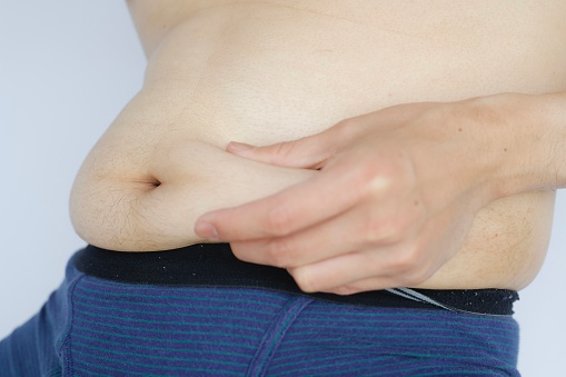 A close-up of the belly of a Japanese man who has stored fat.