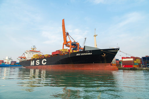 icel, Turkey - December, 22 2019 : Container ship MSC in international port, Turkey. The largest container port of Turkey by handling approximately 2 million TEU per year, Mersin International Port (MIP) is ranked among the world's largest 100 ports. The container vessel loading and discharging operations at the terminal.
