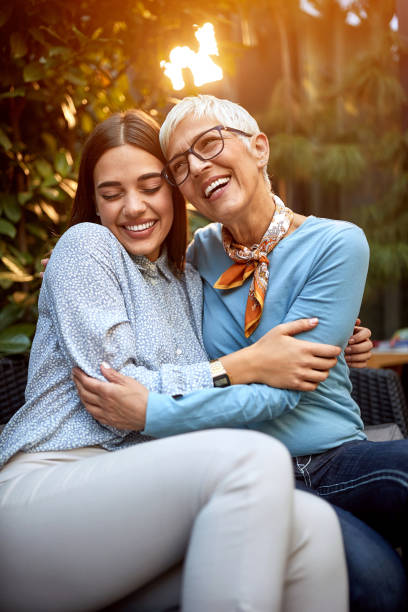 istock Woman with mother sitting embraced 1310602302
