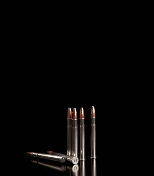 Bullet isolated on black background with reflexion. Rifle bullets close-up on black back. Cartridges for rifle and carbine on a black.