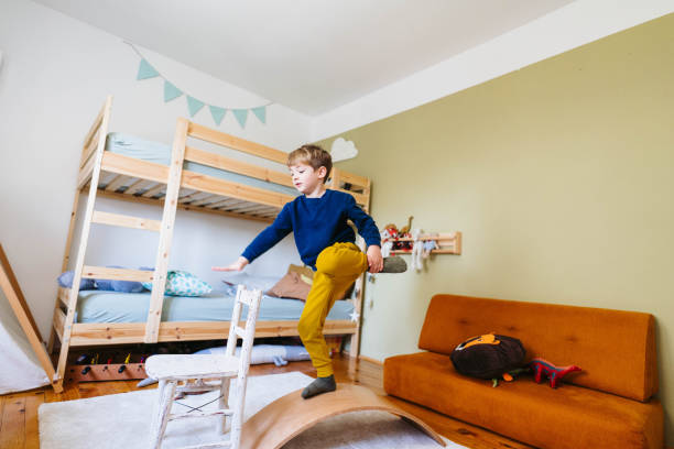 istock Little boy's playing with balance board in his room 1310607236