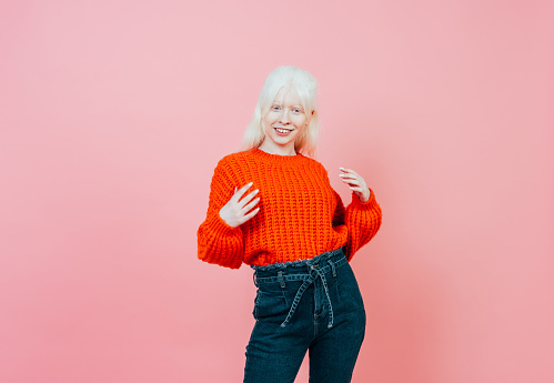 Lifestyle image of an albino girl posing in studio. Concept about body positivity, diversity, and fashion