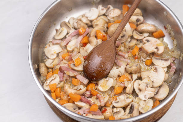 istock Cooking mushrooms with onions carrots and bacon. 1310607479
