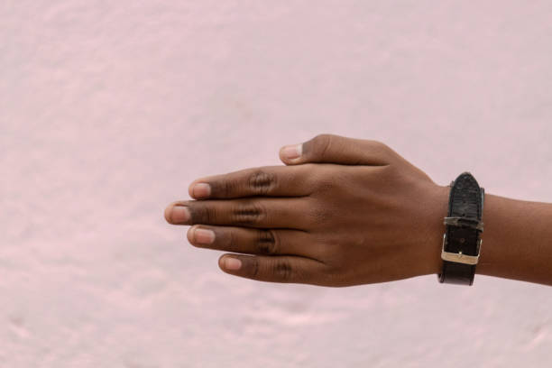 istock Hand against the coloured wall 1310610591